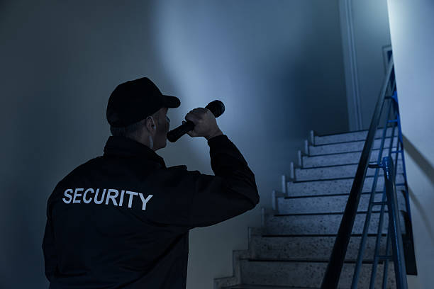security guard using a flashlight on stairways